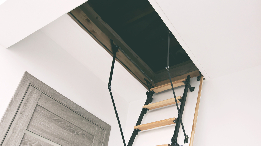 Wooden staircase to the attic in the house